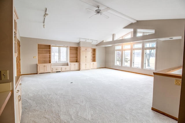 unfurnished living room featuring vaulted ceiling with beams, baseboards, and light colored carpet