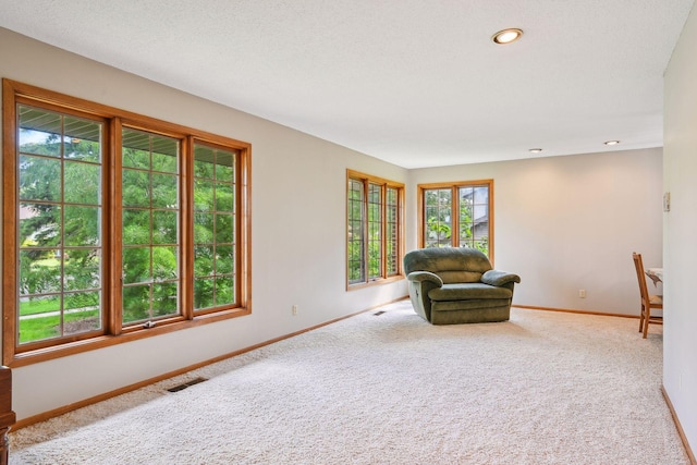 sitting room featuring carpet, visible vents, baseboards, and recessed lighting