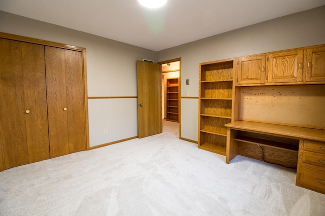 unfurnished bedroom with light colored carpet and baseboards