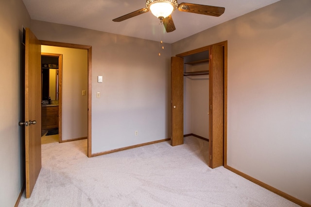 unfurnished bedroom featuring baseboards, a closet, and light colored carpet