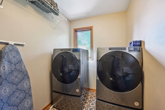 laundry room featuring laundry area, baseboards, independent washer and dryer, tile patterned flooring, and a textured ceiling