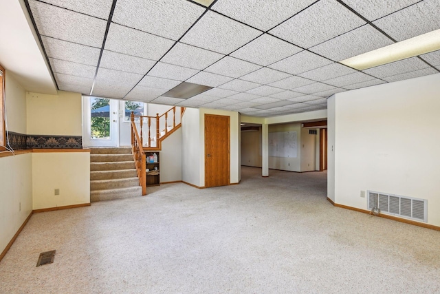 below grade area with carpet floors, stairway, visible vents, and baseboards