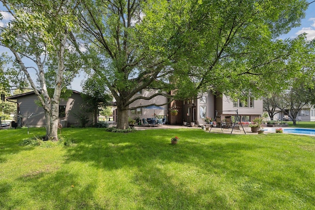 view of yard featuring a patio area and an outdoor pool