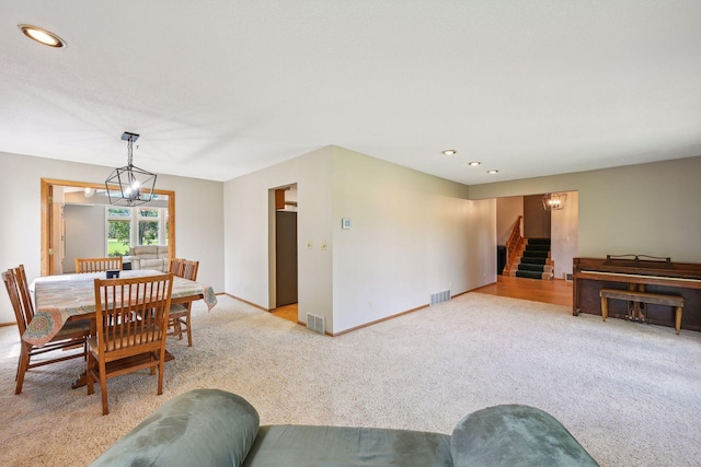living room featuring a chandelier, light carpet, stairway, recessed lighting, and baseboards