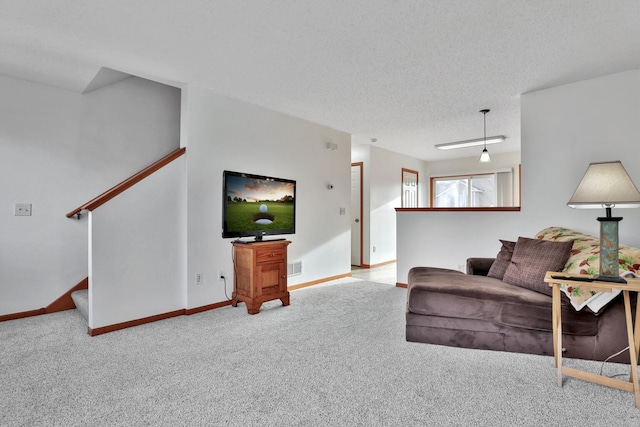 living area with visible vents, baseboards, carpet floors, stairs, and a textured ceiling