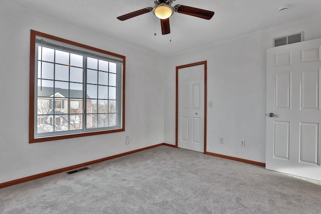 unfurnished bedroom featuring visible vents, baseboards, and carpet