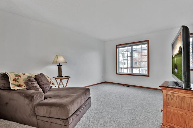 sitting room with visible vents, carpet floors, and baseboards