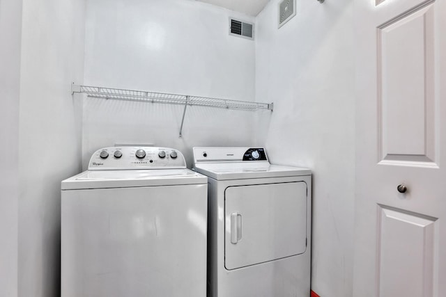 laundry area featuring washer and dryer, visible vents, and laundry area