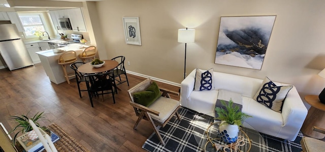 living room featuring dark wood-style floors and baseboards