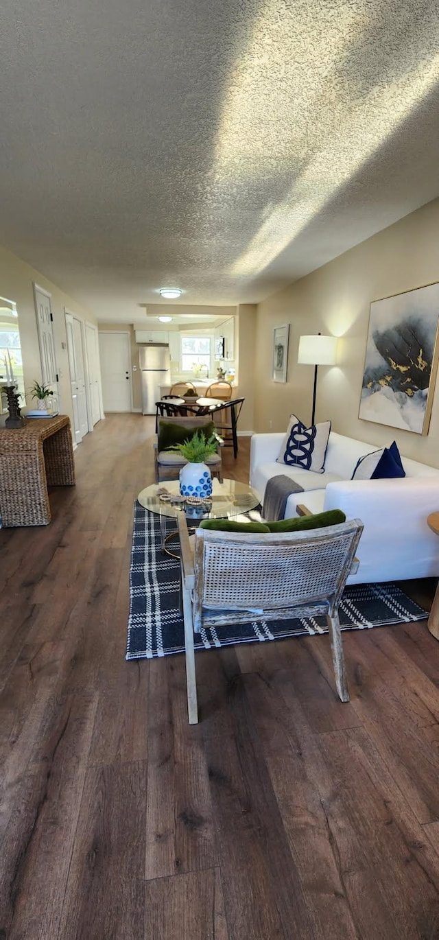 living room with a textured ceiling and wood finished floors