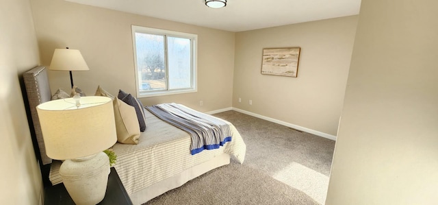 bedroom featuring carpet and baseboards