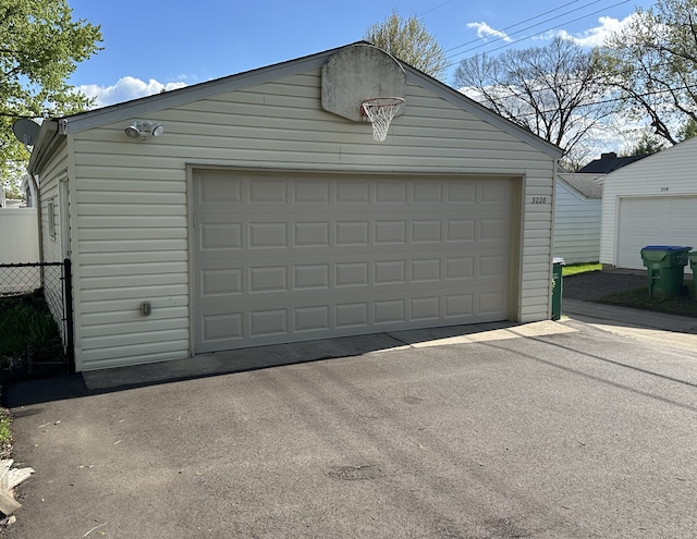 detached garage featuring fence