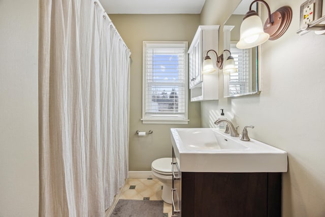 full bath with curtained shower, vanity, toilet, and baseboards