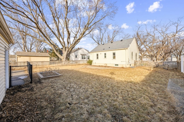 view of yard featuring a fenced backyard and a garden