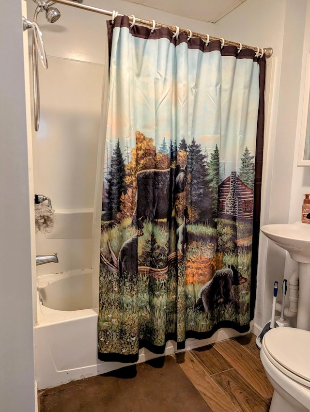 bathroom featuring shower / bath combo, wood finished floors, and toilet