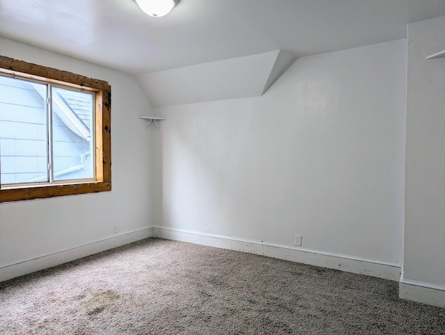 additional living space featuring lofted ceiling, carpet, and baseboards