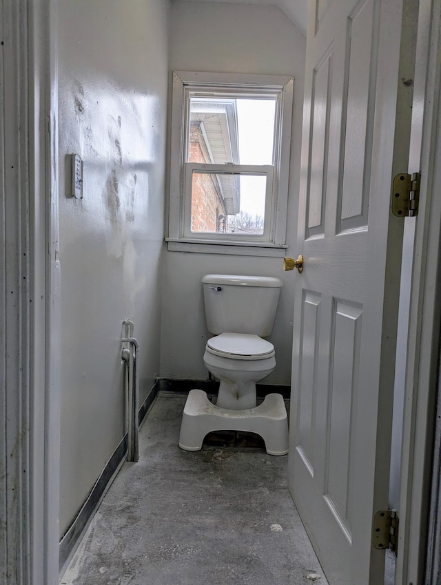 bathroom with toilet and baseboards