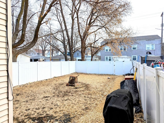 view of yard with a residential view and a fenced backyard