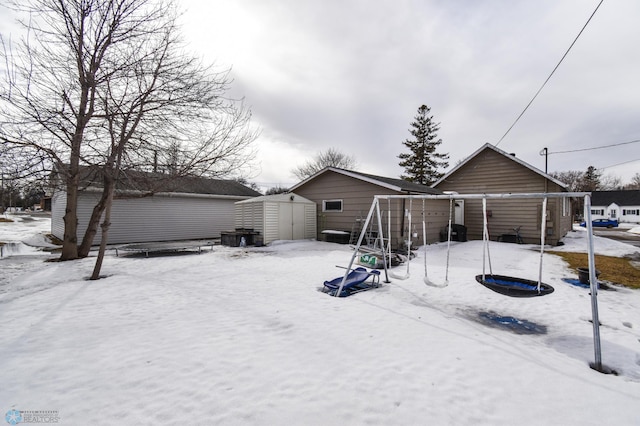 yard covered in snow with an outbuilding and a shed