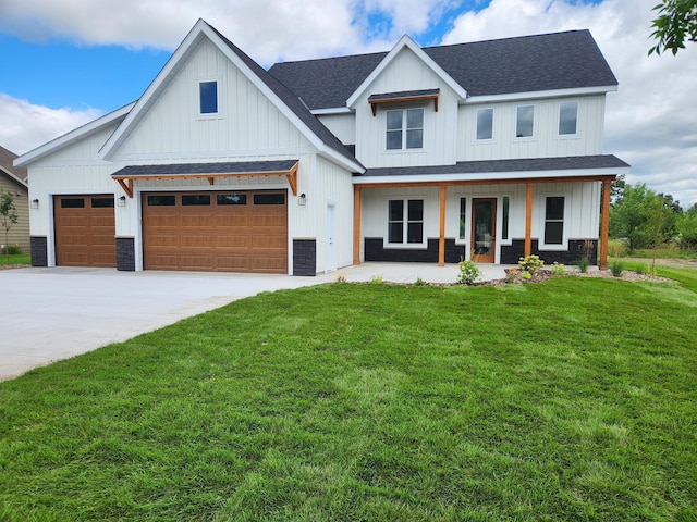 modern farmhouse featuring driveway, a shingled roof, a porch, and a front lawn