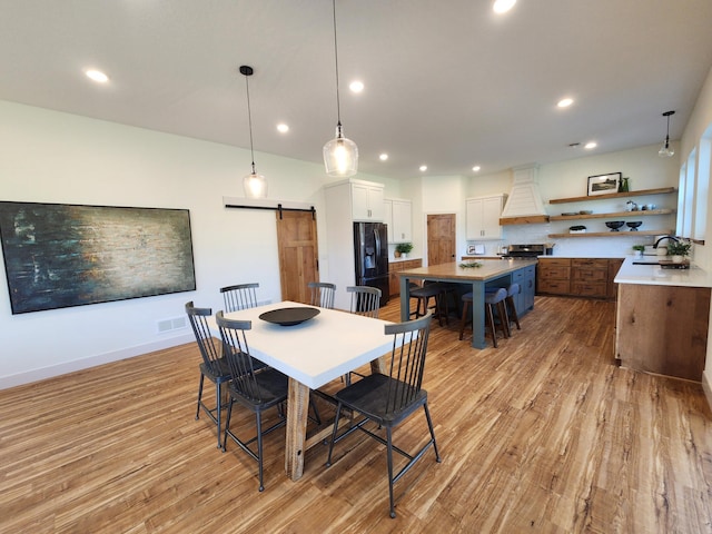 6624 Captains Cir NW, Sauk Rapids, MN 56379 - dining area featuring a barn door, light wood-style floors, recessed lighting, and baseboards