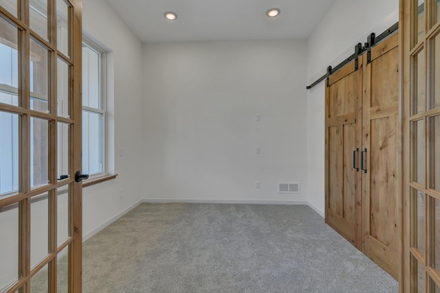 6624 Captains Cir NW, Sauk Rapids, MN 56379 - unfurnished bedroom with carpet floors, a barn door, french doors, baseboards, and recessed lighting
