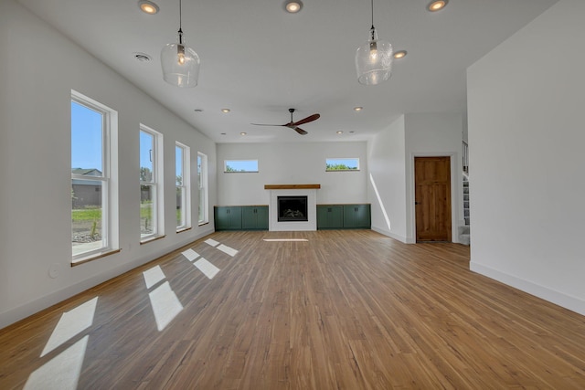 6624 Captains Cir NW, Sauk Rapids, MN 56379 - unfurnished living room featuring healthy amount of natural light, wood finished floors, baseboards, recessed lighting, and a fireplace