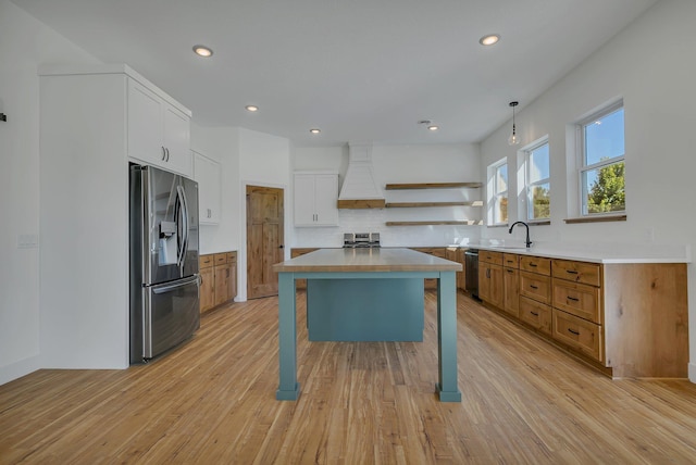 6624 Captains Cir NW, Sauk Rapids, MN 56379 - kitchen featuring stainless steel appliances, custom exhaust hood, open shelves, tasteful backsplash, and light wood-type flooring
