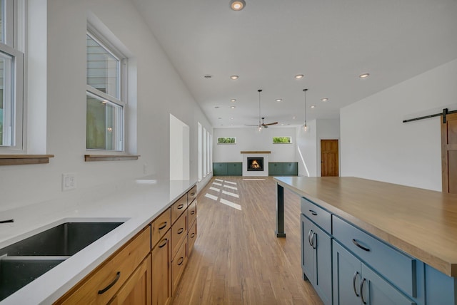 6624 Captains Cir NW, Sauk Rapids, MN 56379 - kitchen featuring a barn door, light wood-style floors, ceiling fan, recessed lighting, and open floor plan