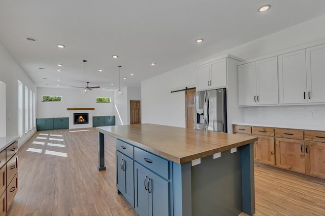 6624 Captains Cir NW, Sauk Rapids, MN 56379 - kitchen with stainless steel fridge, ceiling fan, light wood finished floors, recessed lighting, and open floor plan
