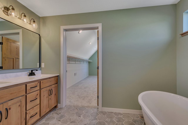 6624 Captains Cir NW, Sauk Rapids, MN 56379 - bathroom featuring double vanity, a freestanding tub, tile patterned floors, lofted ceiling, and baseboards