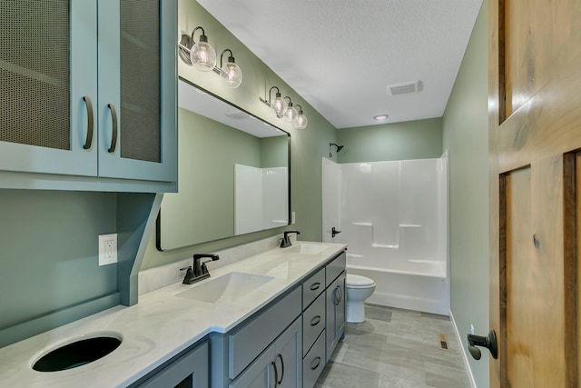 6624 Captains Cir NW, Sauk Rapids, MN 56379 - bathroom featuring toilet, double vanity, washtub / shower combination, and a textured ceiling