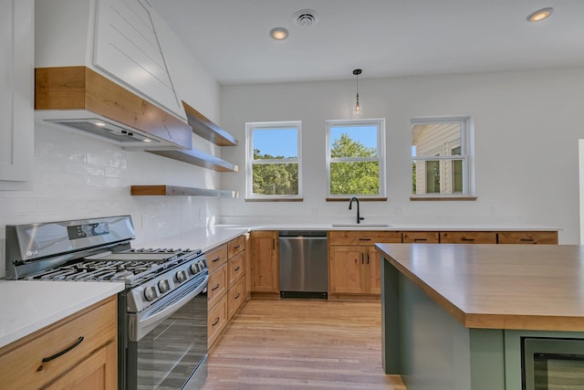 6624 Captains Cir NW, Sauk Rapids, MN 56379 - kitchen with appliances with stainless steel finishes, a sink, tasteful backsplash, light countertops, and light wood-style floors