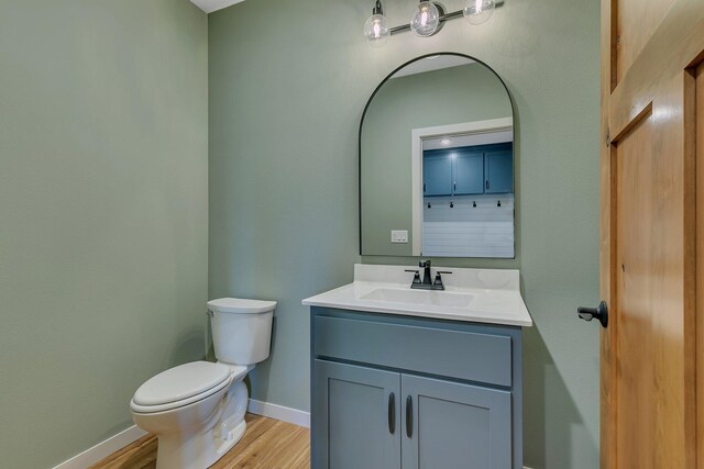 6624 Captains Cir NW, Sauk Rapids, MN 56379 - bathroom featuring toilet, vanity, wood finished floors, and baseboards