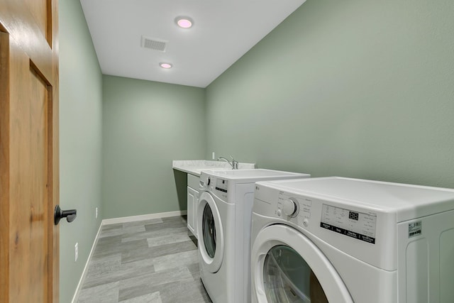6624 Captains Cir NW, Sauk Rapids, MN 56379 - washroom with washing machine and dryer, baseboards, cabinet space, light wood-type flooring, and recessed lighting