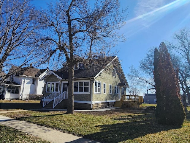 view of side of home featuring a wooden deck and a yard