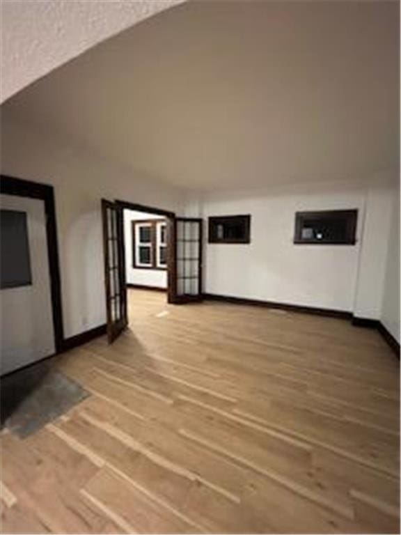 additional living space featuring wood finished floors