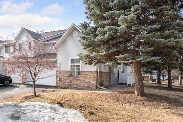 view of side of property with brick siding and driveway