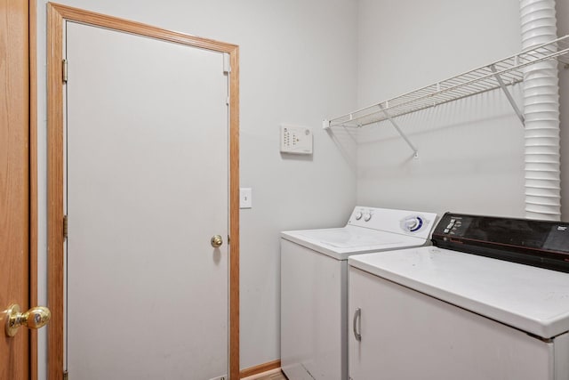 clothes washing area with laundry area and washer and dryer