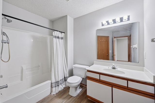 full bathroom with a textured ceiling, toilet, wood finished floors, vanity, and shower / tub combo with curtain