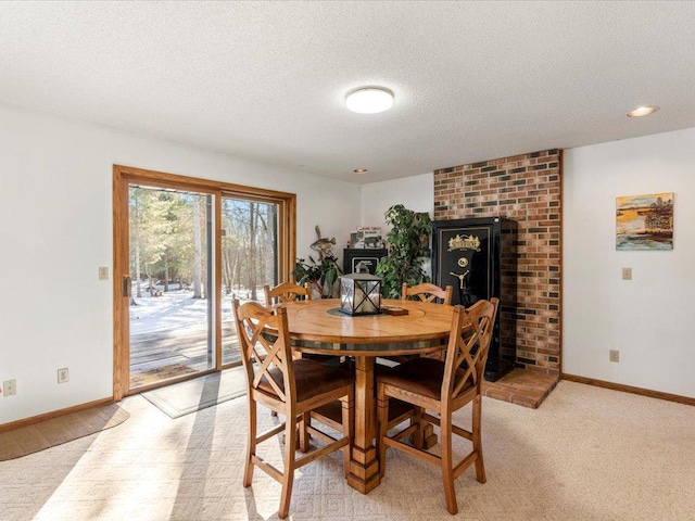 dining space featuring baseboards and a textured ceiling