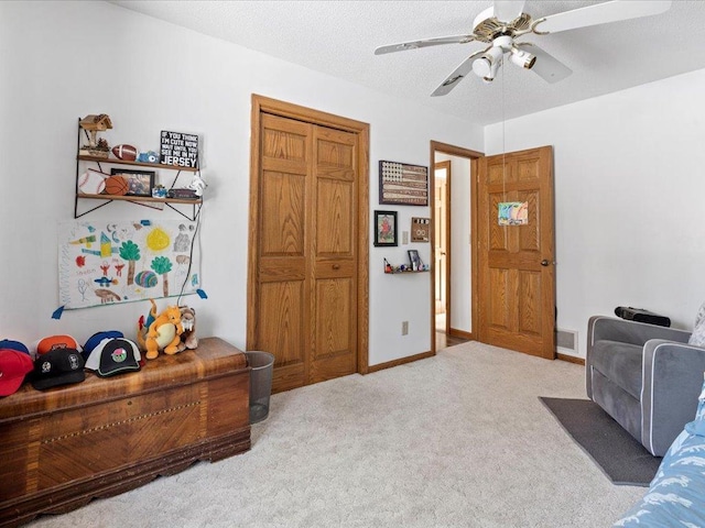 interior space with baseboards, visible vents, ceiling fan, a textured ceiling, and carpet flooring