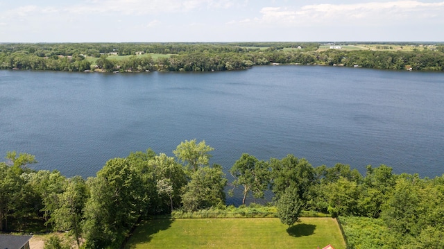 exterior space with a water view and a forest view