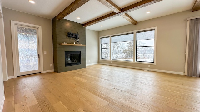 unfurnished living room with recessed lighting, a large fireplace, baseboards, light wood-type flooring, and beam ceiling