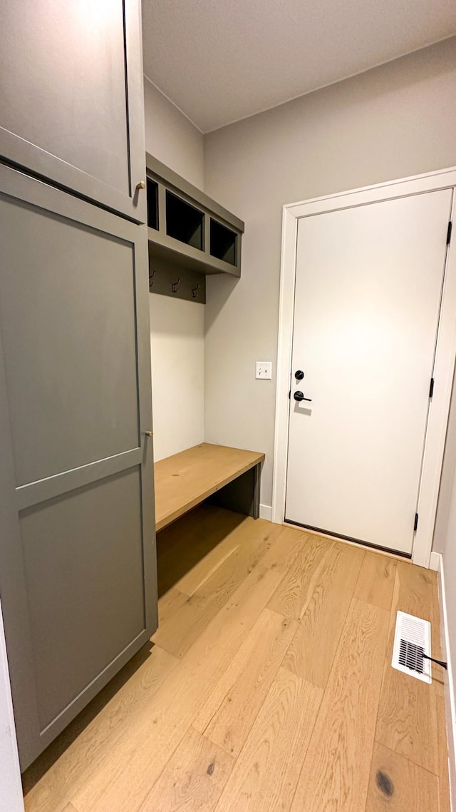 mudroom with light wood-type flooring and visible vents