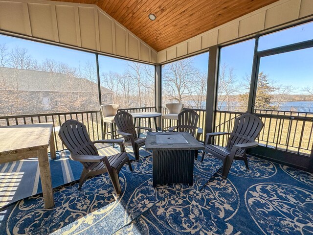 sunroom / solarium with a water view, wooden ceiling, and vaulted ceiling