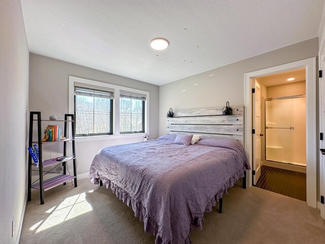 carpeted bedroom featuring a textured ceiling and baseboards