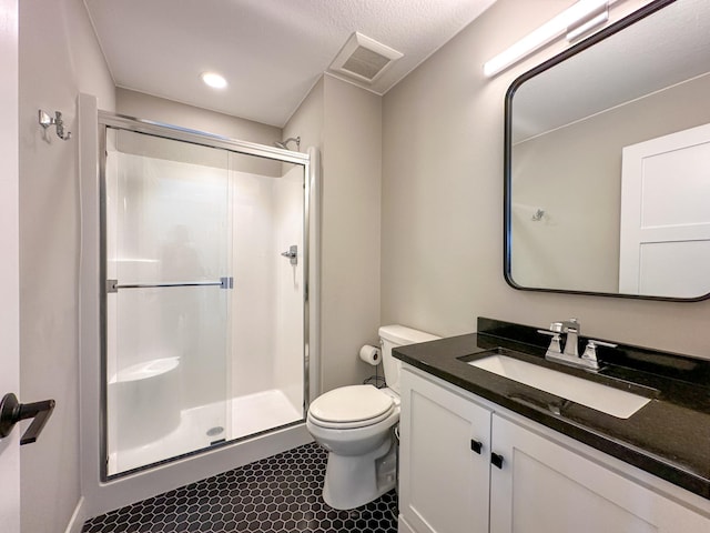 bathroom featuring visible vents, toilet, a shower stall, vanity, and tile patterned flooring