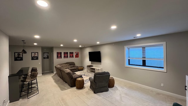 living area featuring recessed lighting, light carpet, and baseboards