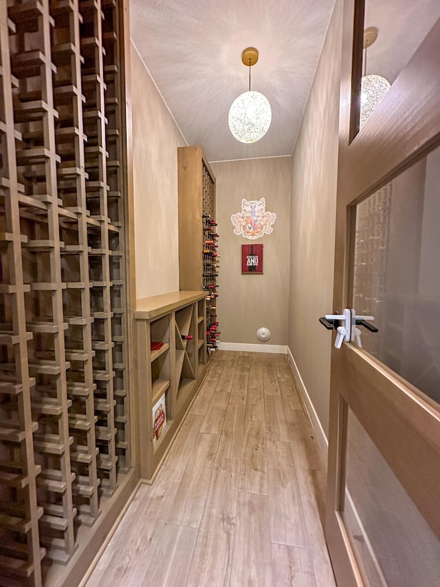 wine area with wood finished floors and baseboards